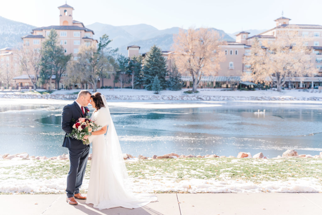 Winter Wedding at The Broadmoor Colorado Springs Lake with Swans Bride and Groom Picture 