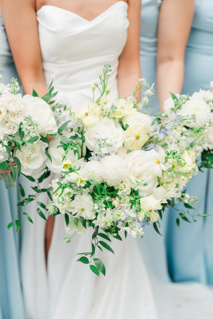 White and green wedding bouquets against soft blue bridesmaid dresses