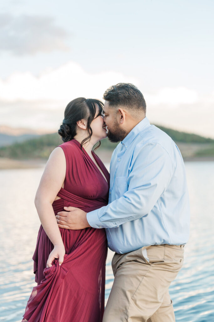 Cathie and Jesse share a kiss beside the peaceful waters of Lake Dillon during their engagement session.